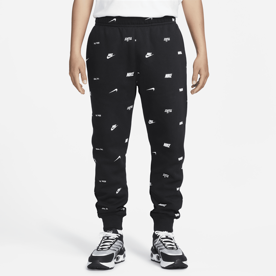 Nike all over logo print joggers in discount camel