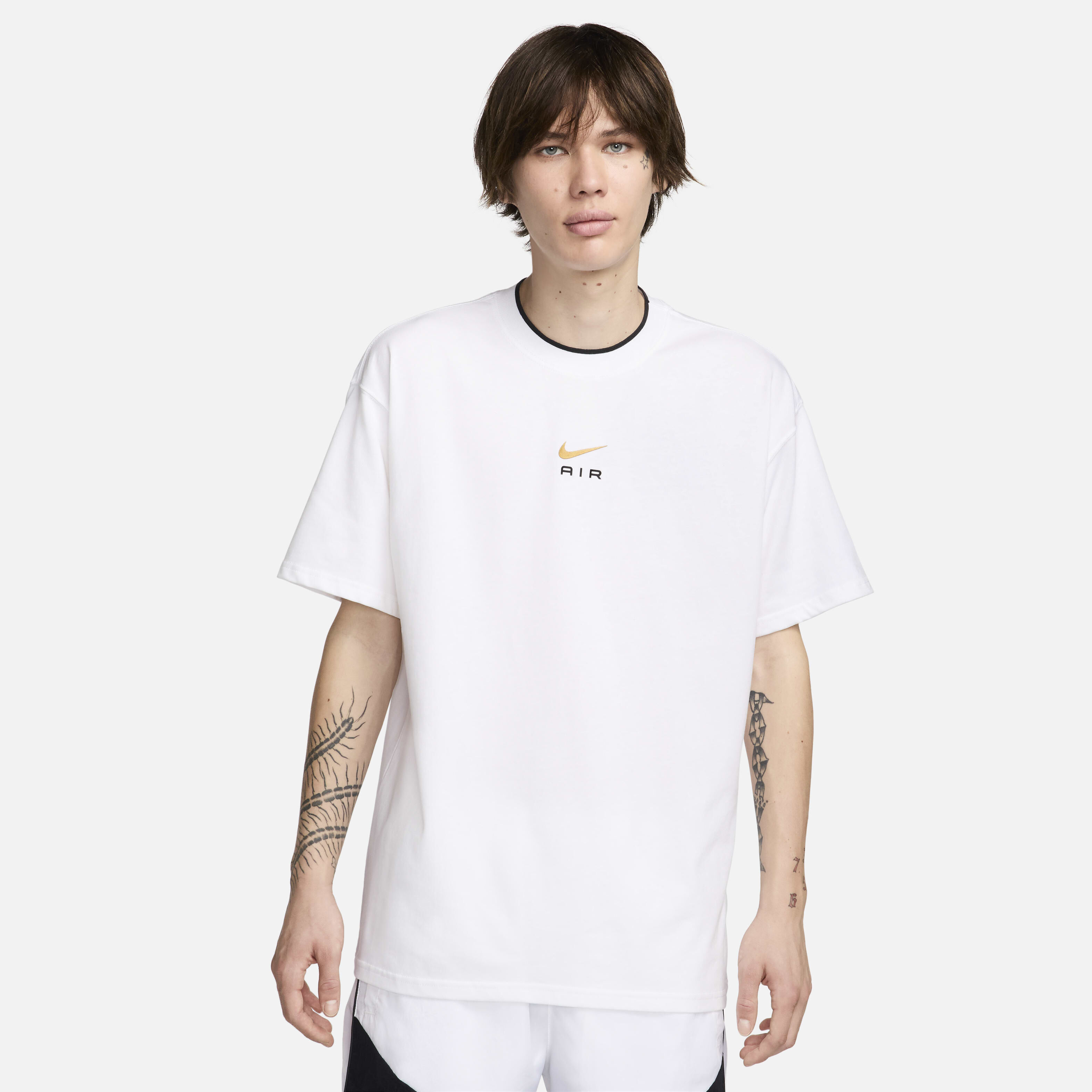 white nike shirt with gold swoosh